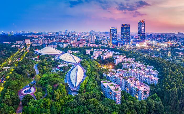 Modern residential and commercial buildings of Baiyun District, Guangzhou, with green hills around