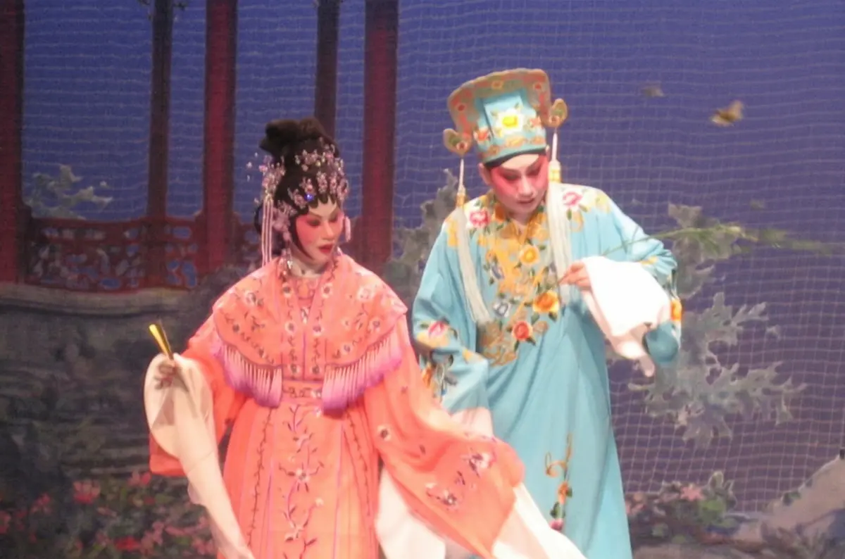 Traditional Cantonese opera performance with elaborate costumes and stage makeup