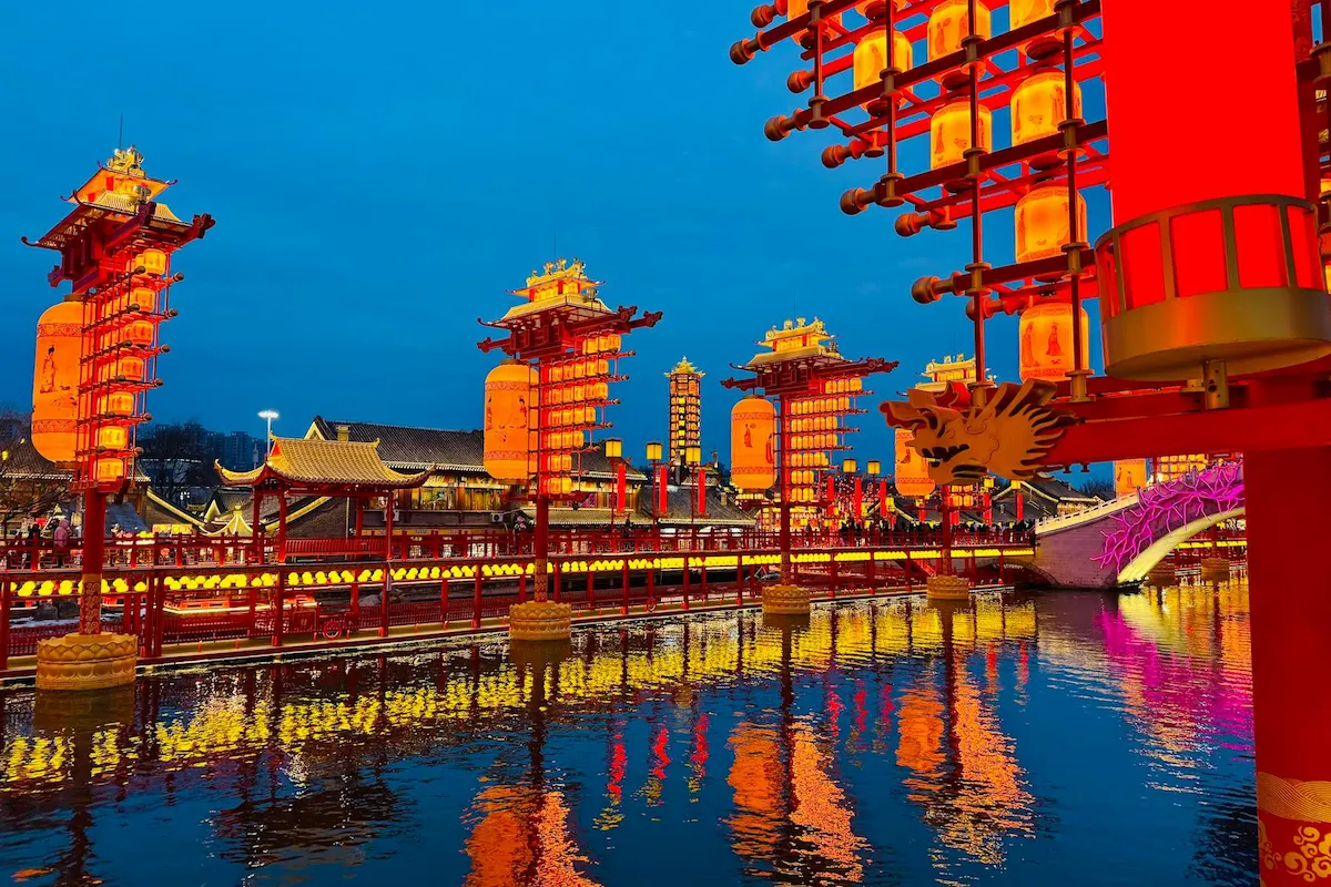 Lakeside bars with glowing lights reflected in Houhai Lake at night in Beijing