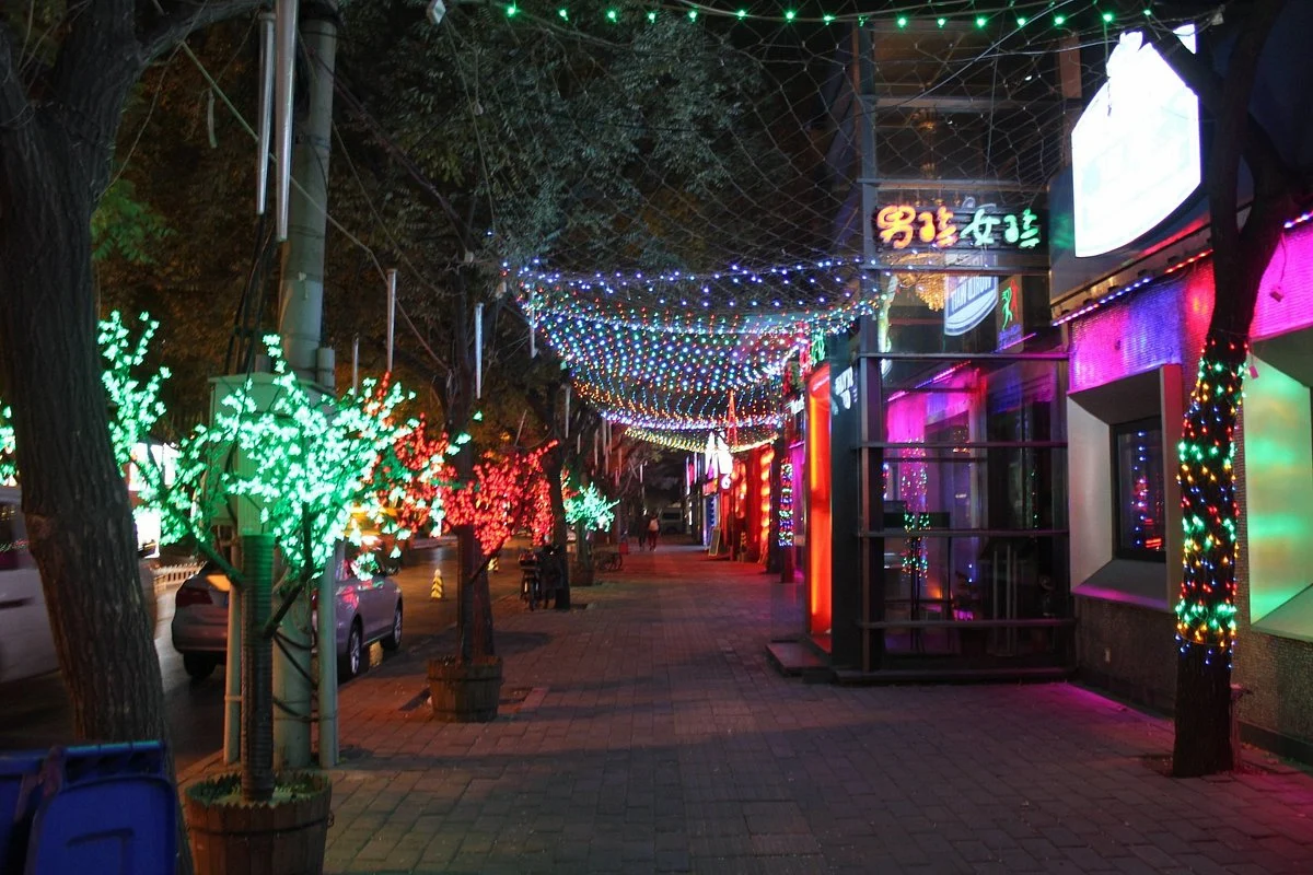 Sanlitun nightlife district in Beijing lit up with neon signs at night