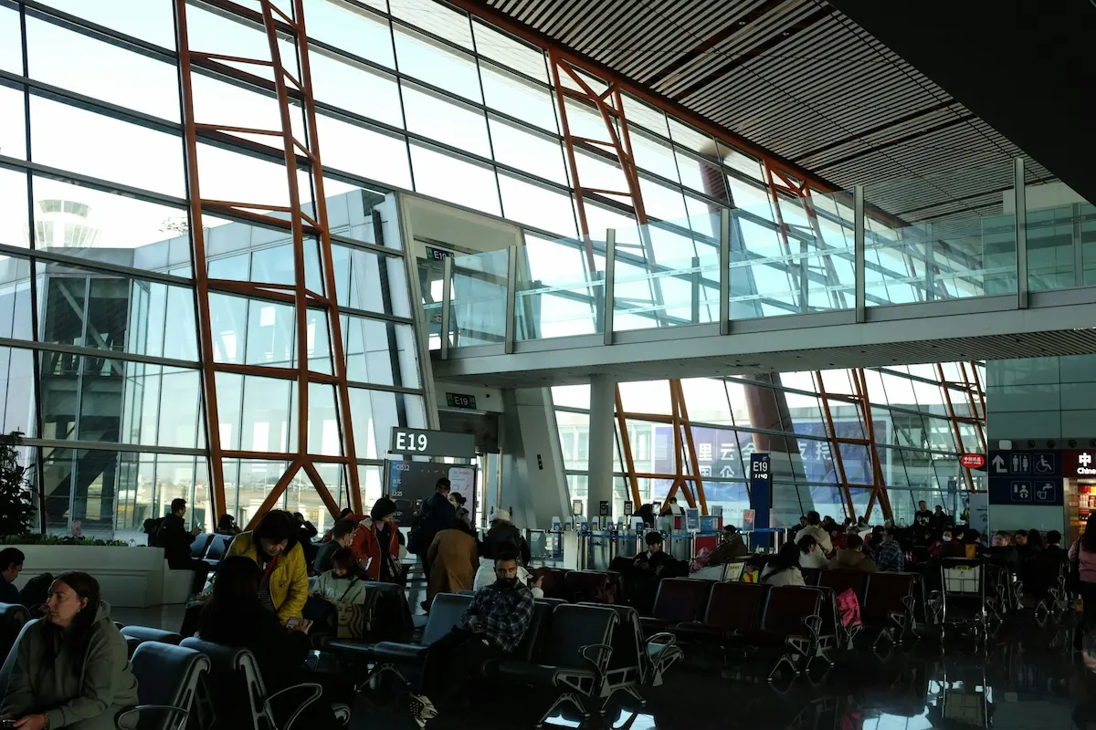 Crowded airport terminal gate area during a flight delay