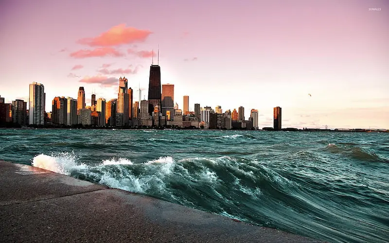 Chicago skyline reflecting on Lake Michigan at sunset