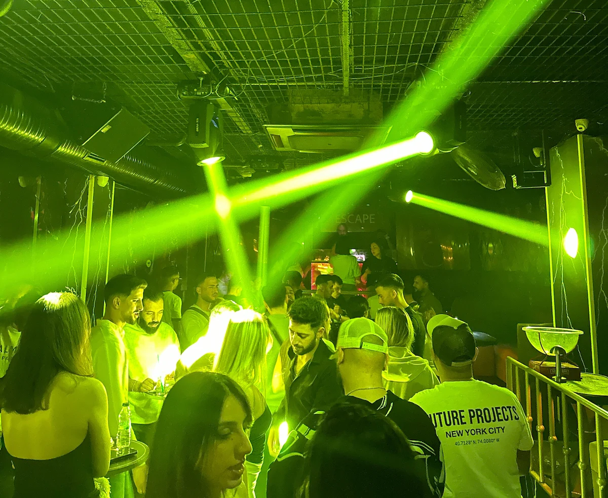 People partying under the green lighting of Escape Istanbul