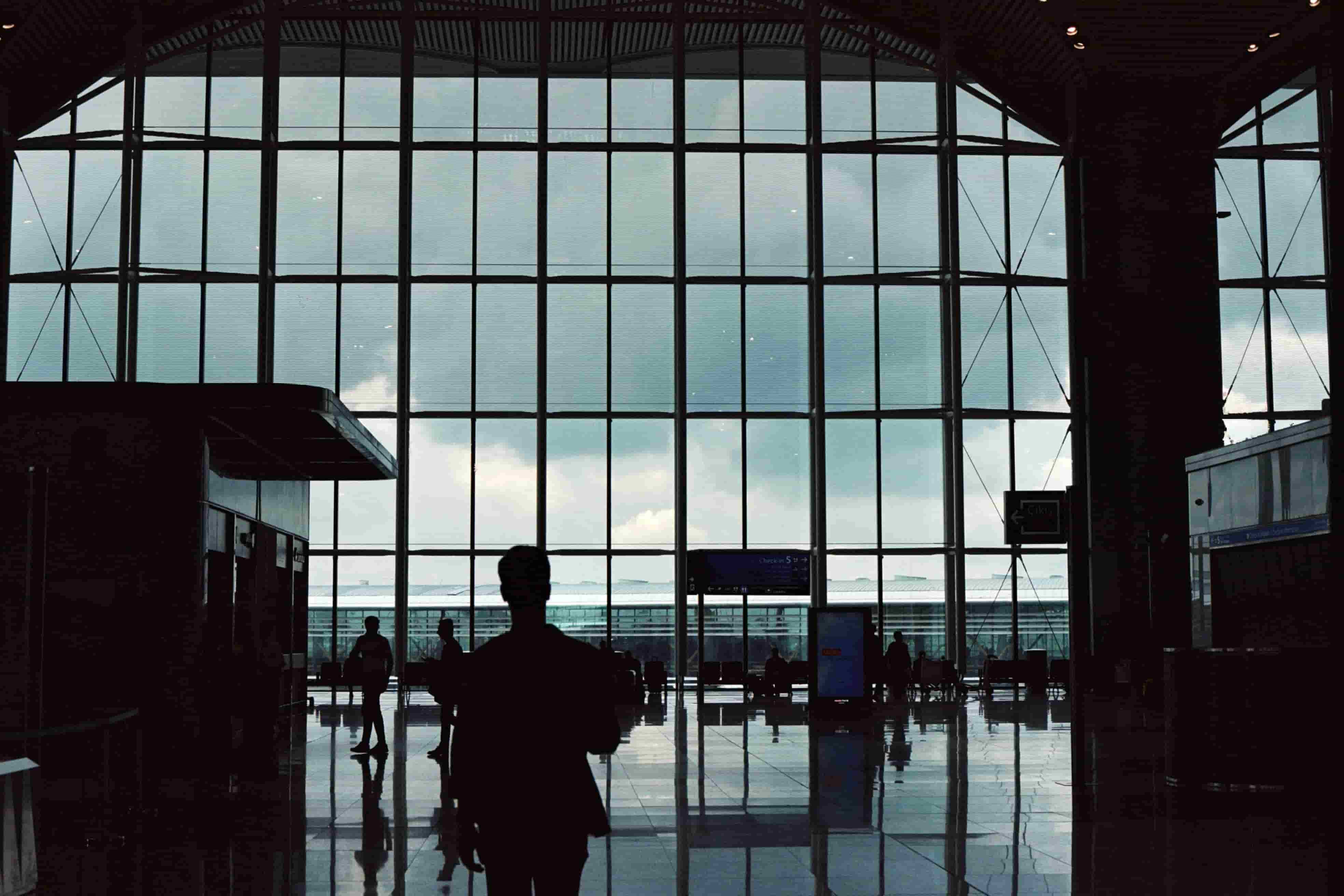 People using priority lanes in a busy airport setting