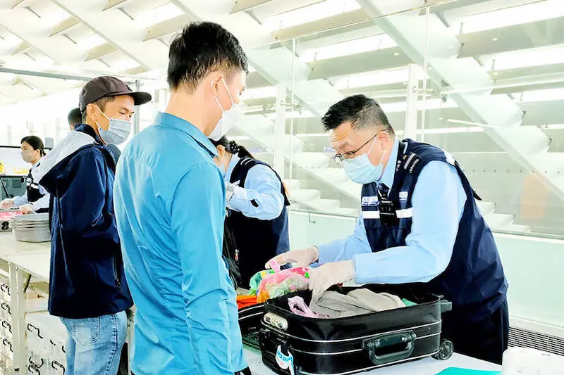 Taiwan Customs Officer (Hai Guan) inspecting goods