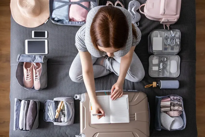 Illustration of a person calmly packing a suitcase